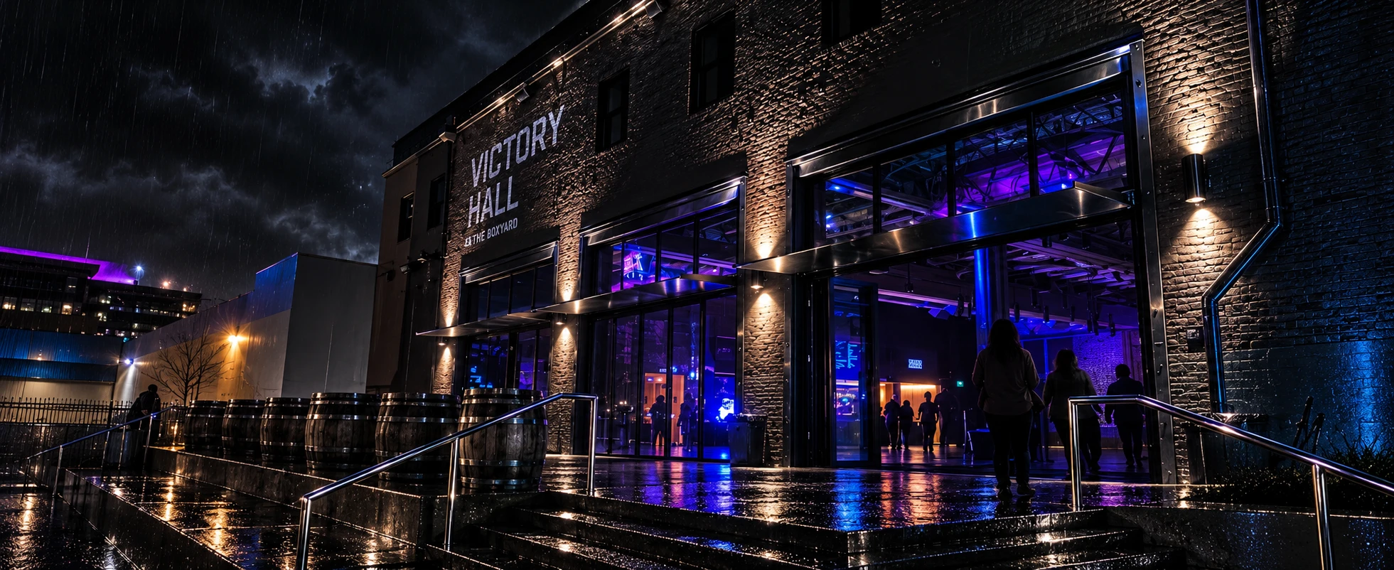 Victory Hall at The Boxyard exterior at night with purple and blue lighting